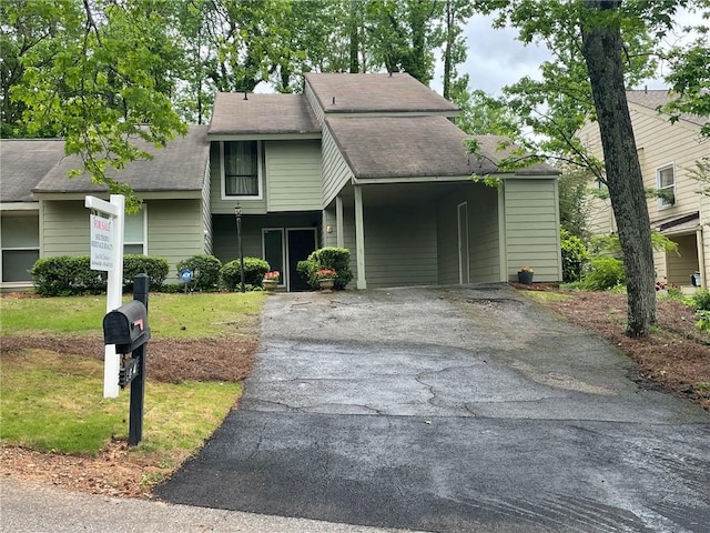 104 Woodhaven Way, Alpharetta, GA 30009 - view of front of house with asphalt driveway, a carport, a front lawn, and a shingled roof