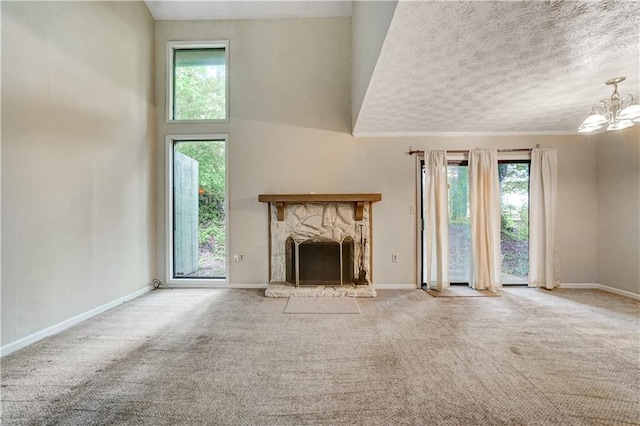 unfurnished living room featuring baseboards, carpet, and plenty of natural light