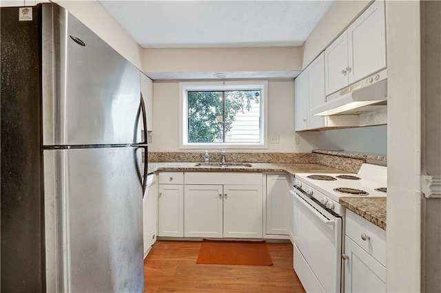 kitchen with light wood-style flooring, a sink, white range with electric stovetop, freestanding refrigerator, and under cabinet range hood