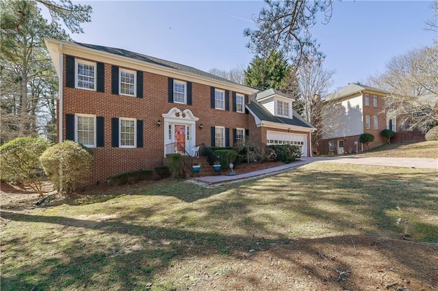 colonial inspired home with a front yard and a garage