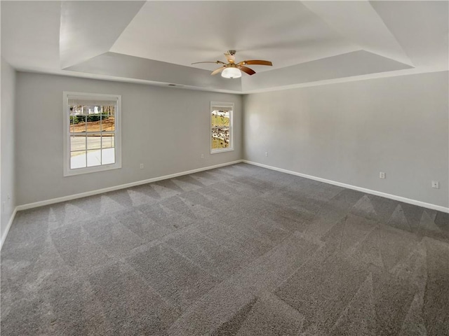 93 Wolfridge Ct, Dallas, GA 30132 - unfurnished room featuring dark colored carpet, a healthy amount of sunlight, a tray ceiling, and ceiling fan