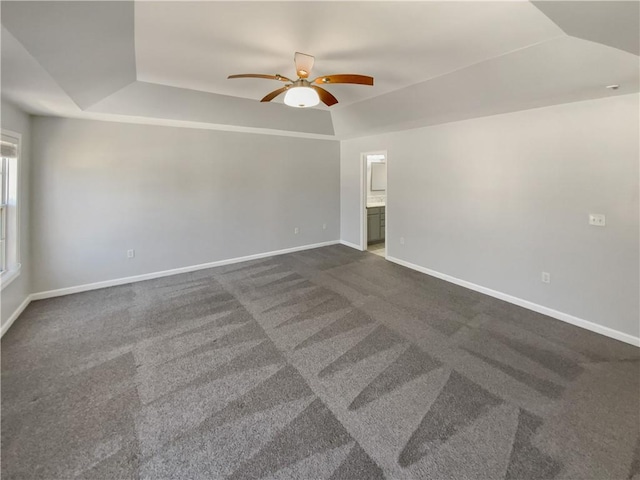 93 Wolfridge Ct, Dallas, GA 30132 - spare room with a raised ceiling, lofted ceiling, dark carpet, baseboards, and ceiling fan