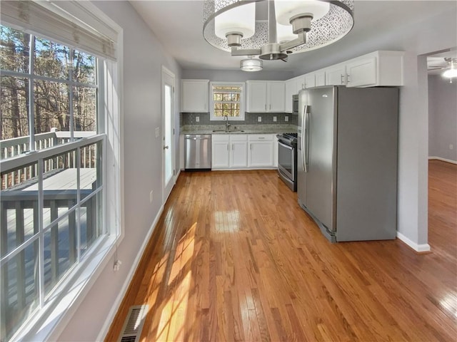 93 Wolfridge Ct, Dallas, GA 30132 - kitchen with white cabinets, a notable chandelier, backsplash, and stainless steel appliances