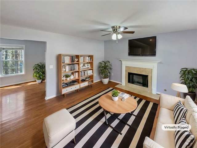 93 Wolfridge Ct, Dallas, GA 30132 - living area featuring baseboards, a fireplace, wood finished floors, and a ceiling fan
