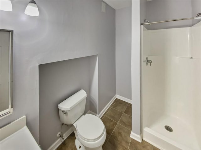 93 Wolfridge Ct, Dallas, GA 30132 - full bathroom featuring tile patterned flooring, toilet, baseboards, and a stall shower