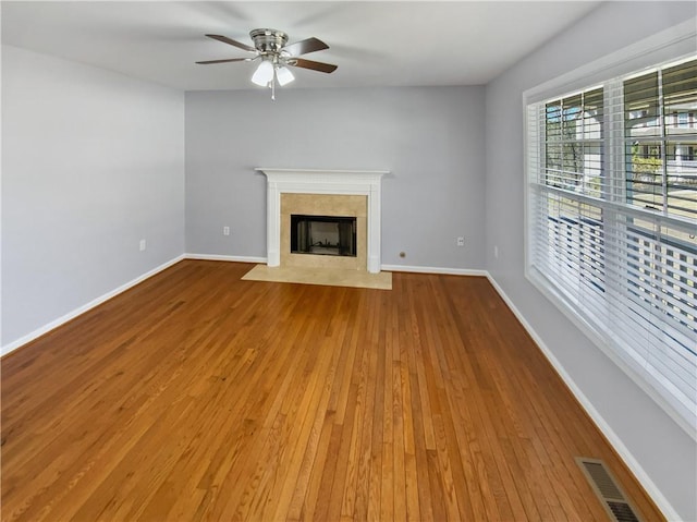 93 Wolfridge Ct, Dallas, GA 30132 - unfurnished living room with visible vents, baseboards, ceiling fan, and wood finished floors
