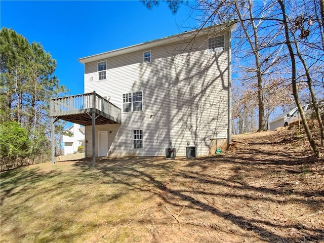 93 Wolfridge Ct, Dallas, GA 30132 - rear view of house with a deck, a lawn, and central AC