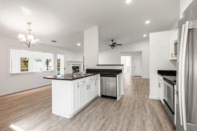 kitchen featuring appliances with stainless steel finishes, a sink, light wood-style floors, and white cabinets