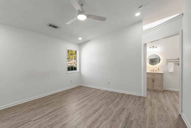 unfurnished bedroom featuring recessed lighting, light wood-type flooring, visible vents, and baseboards