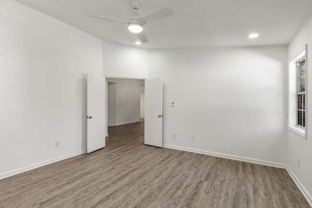 spare room featuring ceiling fan, baseboards, wood finished floors, and recessed lighting