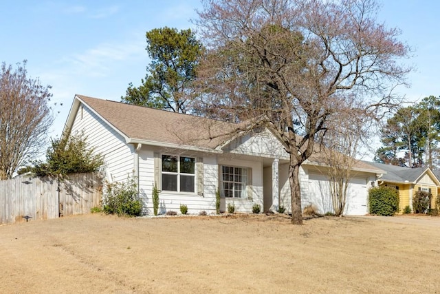 ranch-style home with an attached garage, driveway, and fence