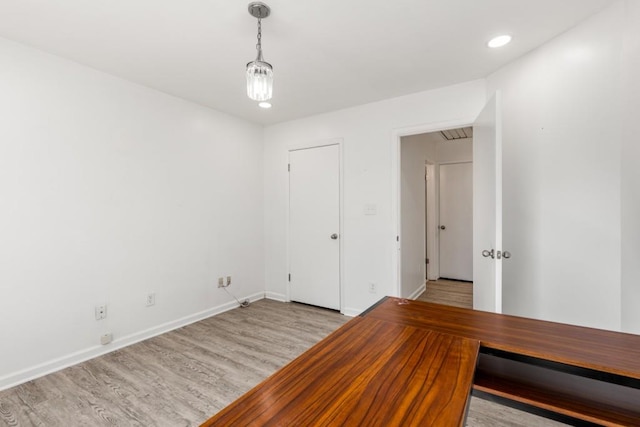 interior space featuring recessed lighting, light wood-type flooring, and baseboards