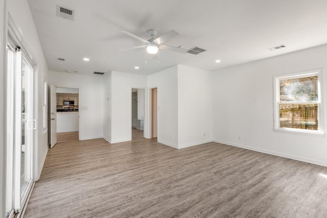 spare room with light wood-style floors, baseboards, visible vents, and recessed lighting