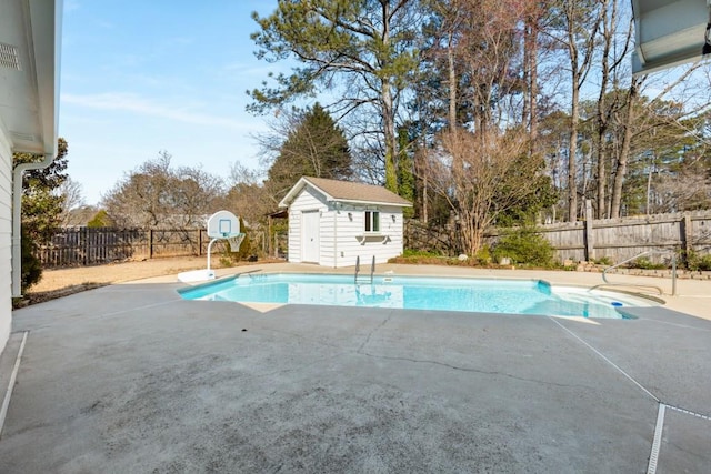 view of swimming pool with a fenced in pool, a fenced backyard, a storage unit, an outdoor structure, and a patio area