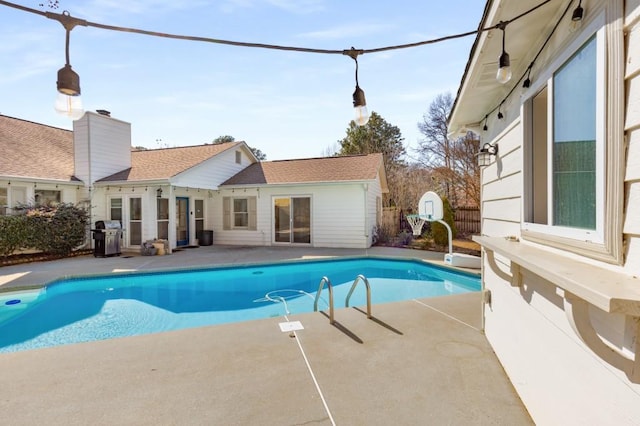 view of swimming pool featuring a fenced in pool, a patio, and area for grilling