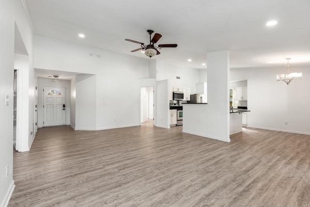 unfurnished living room with light wood-type flooring, baseboards, recessed lighting, and ceiling fan with notable chandelier