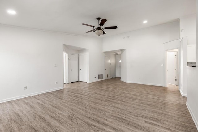 unfurnished living room featuring baseboards, a ceiling fan, and wood finished floors