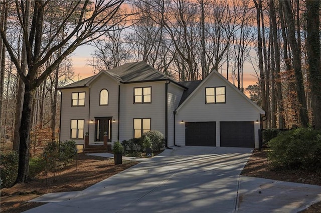 view of front of property featuring concrete driveway and an attached garage