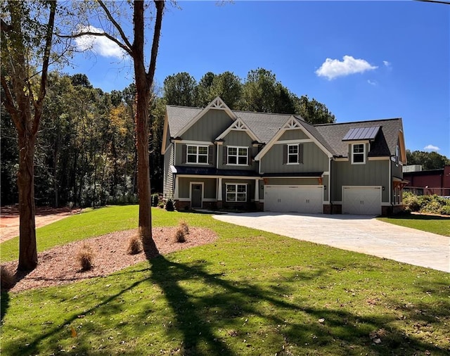 view of front of home with a garage and a front lawn