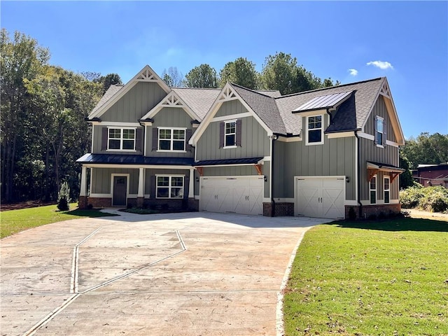 view of front of home with a front yard and a garage