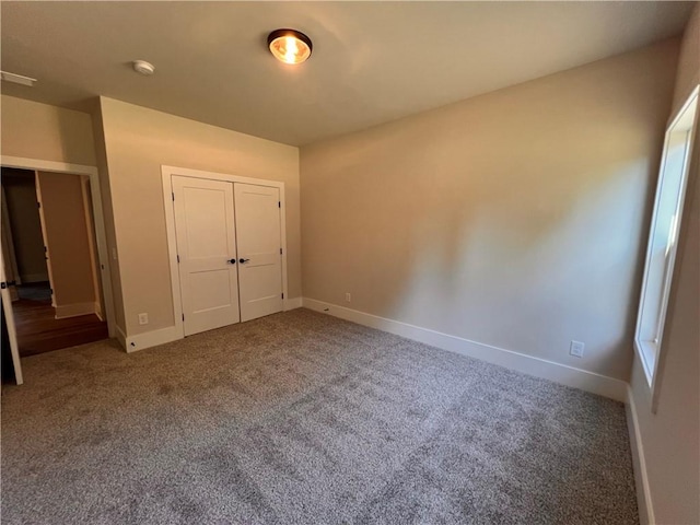 unfurnished bedroom with a closet and carpet floors