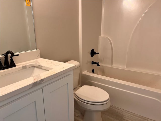 full bathroom with vanity, shower / bathing tub combination, hardwood / wood-style flooring, and toilet