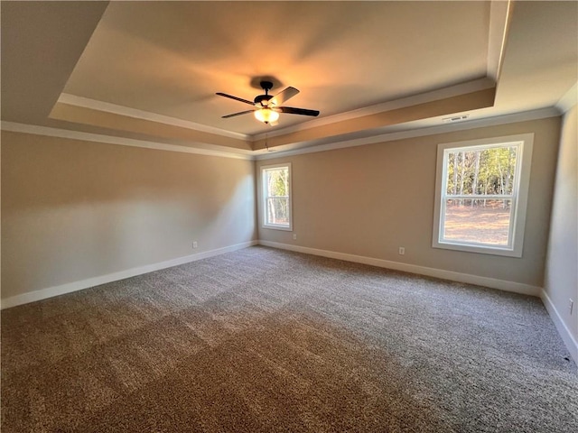 unfurnished room with ornamental molding, carpet floors, a tray ceiling, and ceiling fan