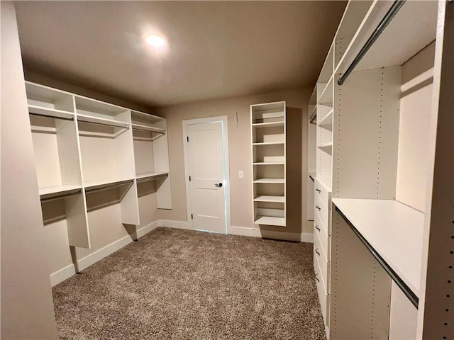 spacious closet with dark carpet