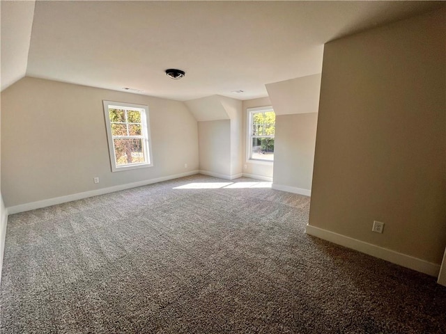 bonus room with carpet floors and vaulted ceiling