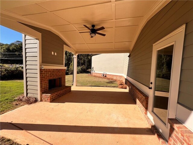 view of patio / terrace featuring an outdoor brick fireplace and ceiling fan