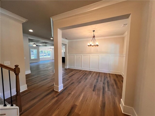 interior space with crown molding, a chandelier, and dark wood-type flooring