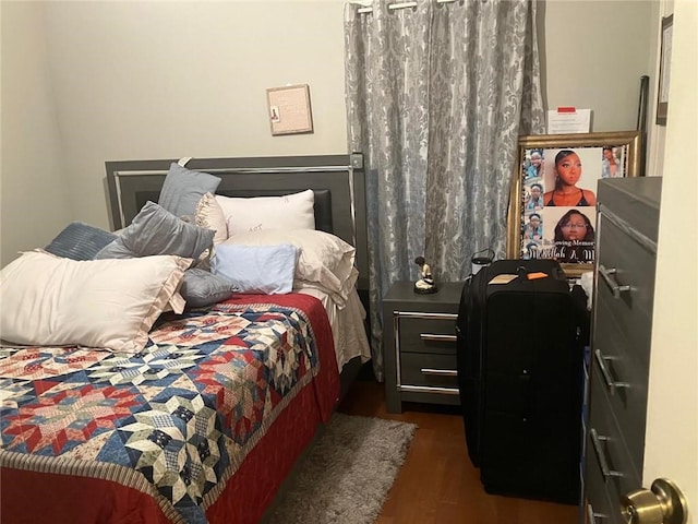 bedroom featuring dark wood finished floors