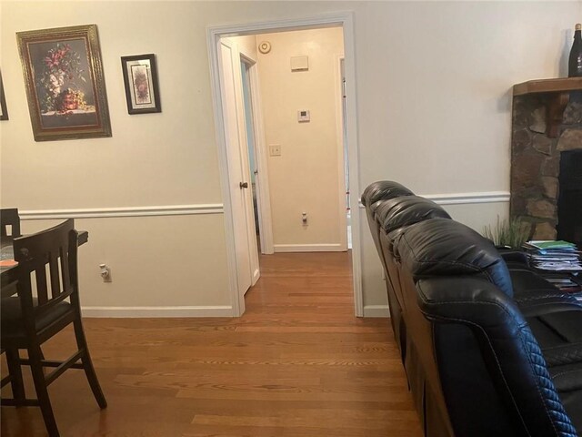 corridor with hardwood / wood-style flooring