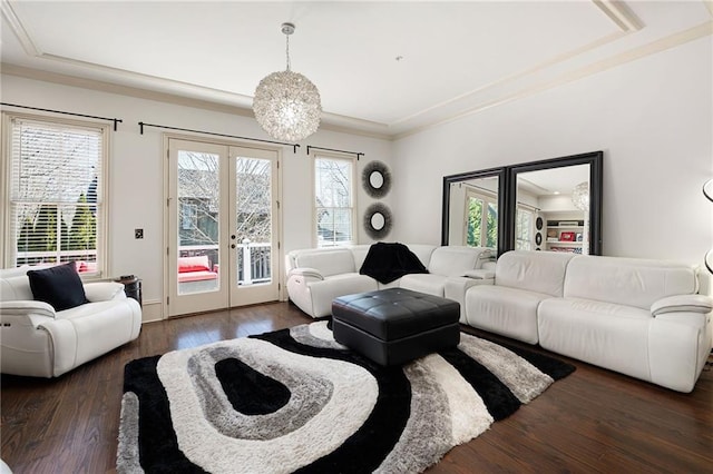 living room with french doors, dark hardwood / wood-style flooring, and a notable chandelier