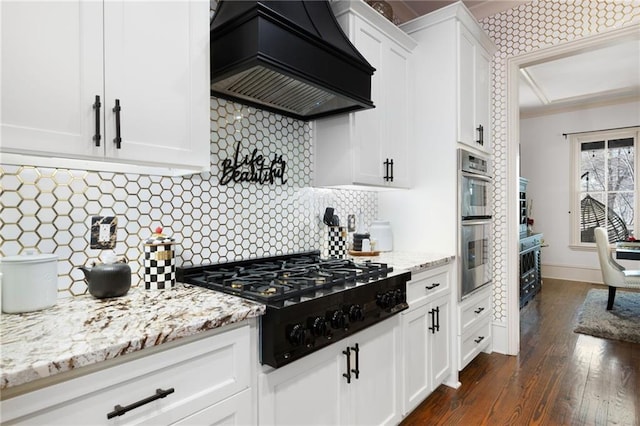 kitchen featuring custom exhaust hood, white cabinetry, dark hardwood / wood-style flooring, black gas stovetop, and backsplash