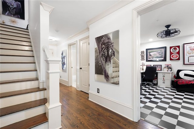 staircase with crown molding and hardwood / wood-style floors