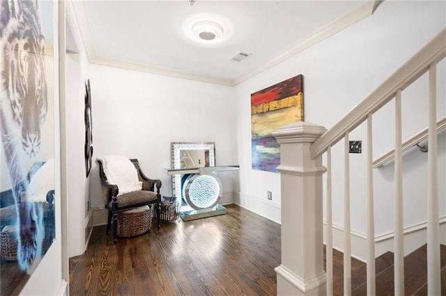 sitting room with crown molding and wood-type flooring