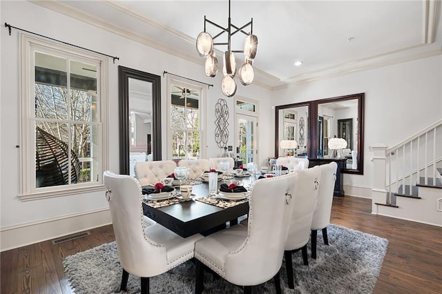 dining area featuring ornamental molding, dark hardwood / wood-style floors, and a notable chandelier