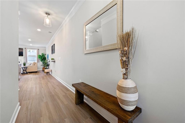 hallway featuring hardwood / wood-style floors and ornamental molding