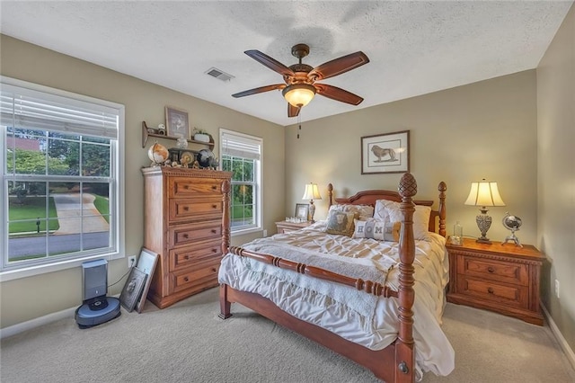 225 Ruby Forest Pkwy, Suwanee, GA 30024 - bedroom with light carpet, multiple windows, a textured ceiling, and ceiling fan