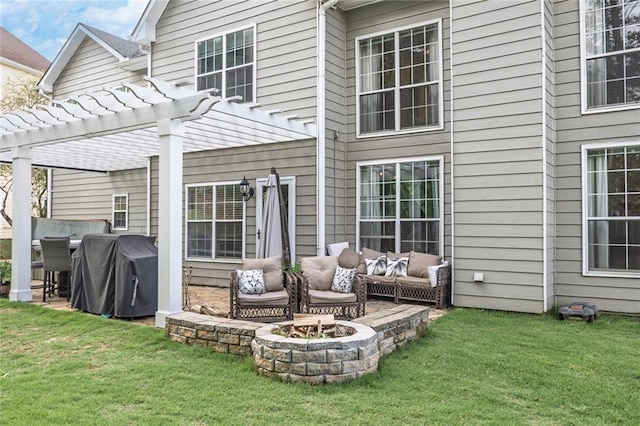 225 Ruby Forest Pkwy, Suwanee, GA 30024 - back of property featuring an outdoor living space with a fire pit, a pergola, a lawn, and a patio