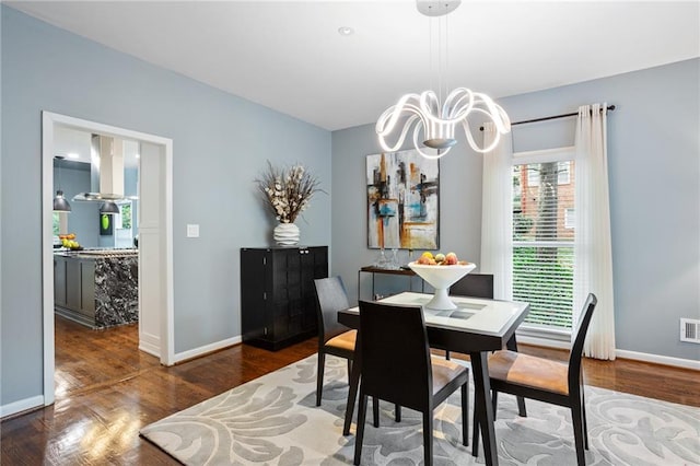 dining room featuring a chandelier and dark hardwood / wood-style floors