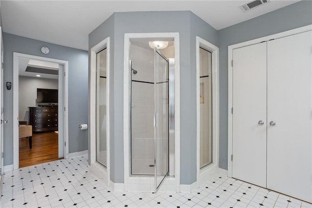 bathroom featuring a shower with door