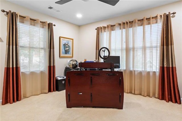 carpeted home office with ceiling fan