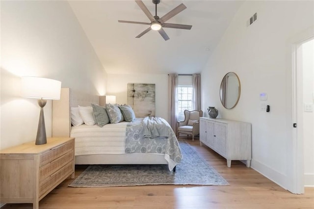 bedroom featuring light hardwood / wood-style flooring, vaulted ceiling, and ceiling fan