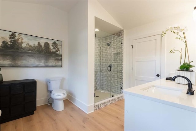 bathroom featuring an enclosed shower, vanity, hardwood / wood-style flooring, toilet, and lofted ceiling