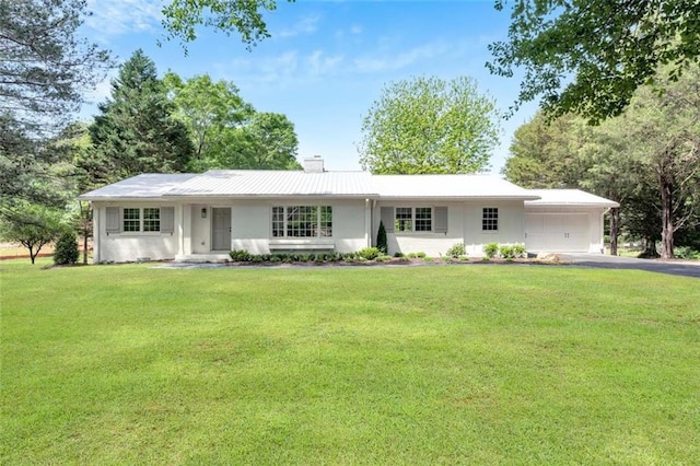 ranch-style house with a garage and a front yard