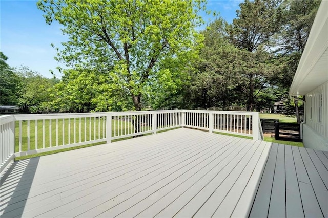 wooden terrace with a lawn