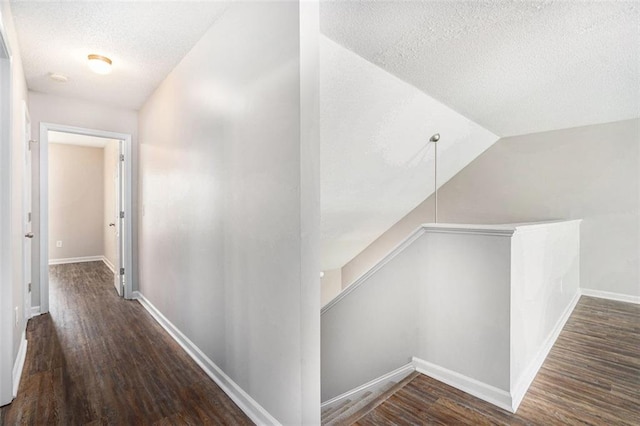 222 Ben Ln, Fairburn, GA 30213 - hall featuring a textured ceiling, wood finished floors, vaulted ceiling, and baseboards