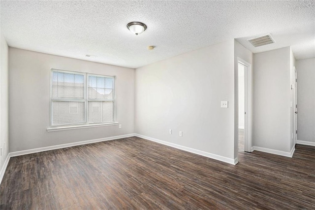 222 Ben Ln, Fairburn, GA 30213 - unfurnished room featuring dark wood-type flooring, a textured ceiling, and baseboards
